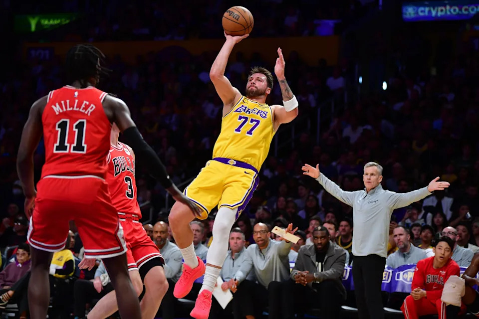 Mar 12, 2026; Los Angeles, California, USA; Los Angeles Lakers guard Luka Doncic (77) shoots against Chicago Bulls guard Josh Giddey (3) and forward Leonard Miller (11) during the first half at Crypto.com Arena. © Gary A. Vasquez-Imagn Images