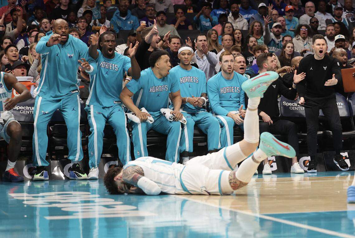 Charlotte Hornets players react as guard LaMelo Ball is fouled during the first quarter of the game against the Philadelphia 76ers on Saturday at Spectrum Center. 
