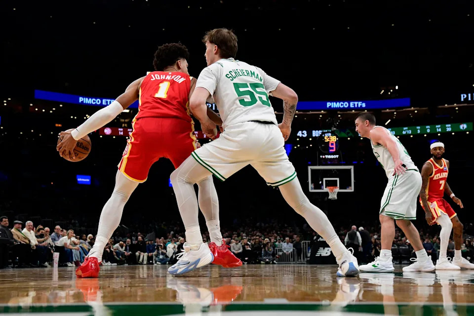 Mar 27, 2026; Boston, Massachusetts, USA; Boston Celtics guard Baylor Scheierman (55) guards Atlanta Hawks forward Jalen Johnson (1) during the first half at TD Garden. Mandatory Credit: Bob DeChiara-Imagn Images