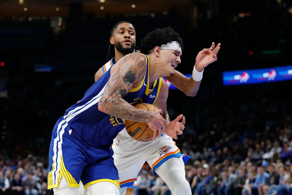 Mar 7, 2026; Oklahoma City, Oklahoma, USA; Golden State Warriors forward Gui Santos (15) drives the ball to the basket as Oklahoma City Thunder guard Isaiah Joe (11) defends during the second half at Paycom Center. Mandatory Credit: Alonzo Adams-Imagn Images