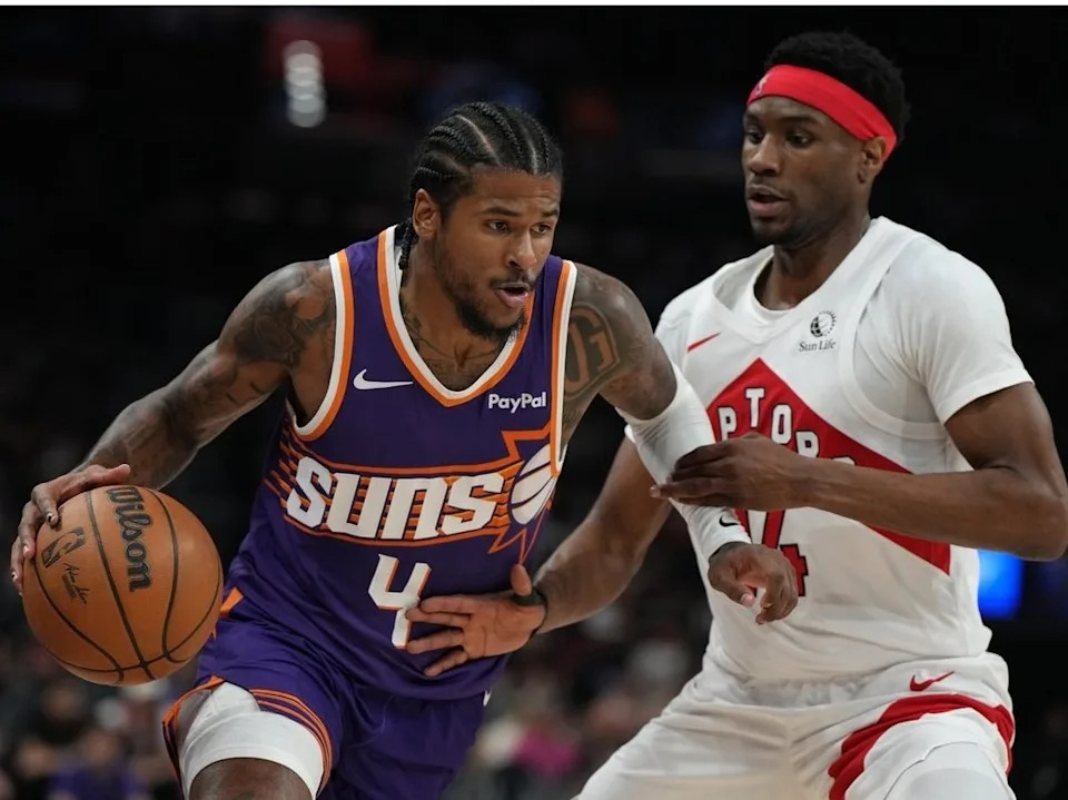 Phoenix Suns guard Jalen Green (4) drives past Toronto Raptors guard Ja’kobe Walter during the first half of an NBA basketball game, Sunday, March 23, 2026, in Phoenix.