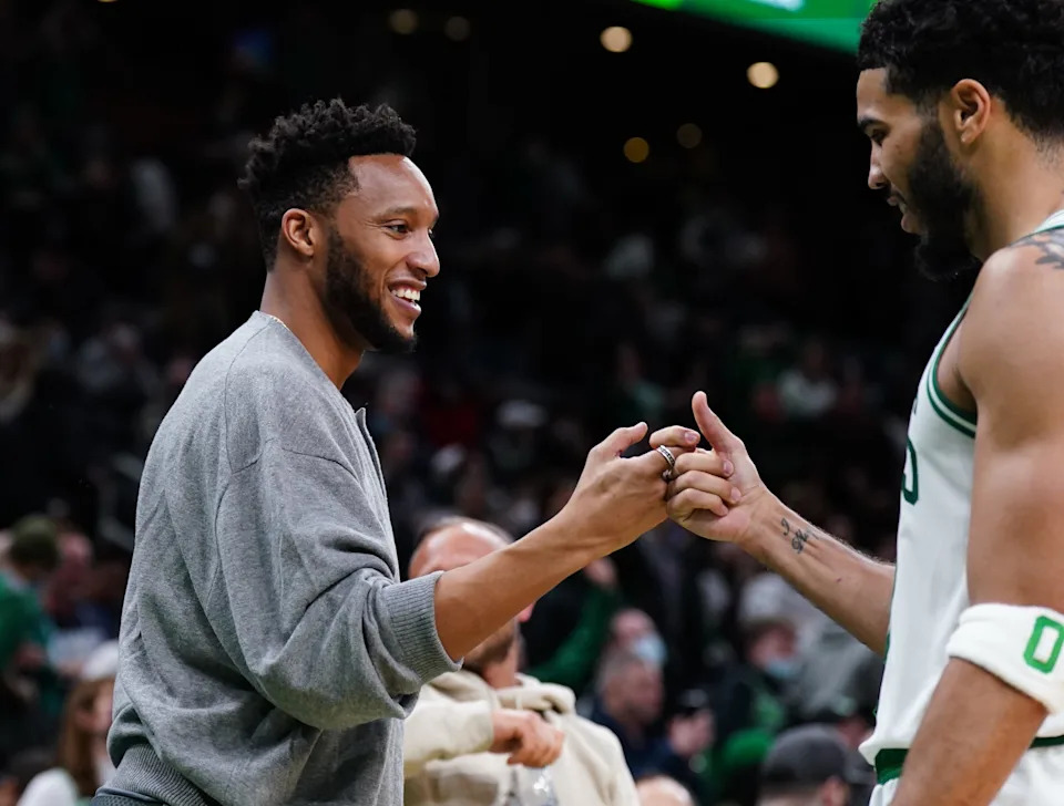 Mar 1, 2022; Boston, Massachusetts, USA; Former NBA player and former assistant coach for the Boston Celtics Evan Turner greets forward Jayson Tatum (0) during a break in the action against the Atlanta Hawks in the second half at TD Garden. Mandatory Credit: David Butler II-USA TODAY Sports