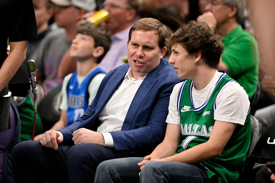 Mar 1, 2026; Dallas, Texas, USA; Dallas Mavericks governor Patrick Dumont (left) sits court side with Mavs fan Nicholas Dickason (right) during the second half of the game against the Oklahoma City Thunder at the American Airlines Center. Mandatory Credit: Jerome Miron-Imagn Images