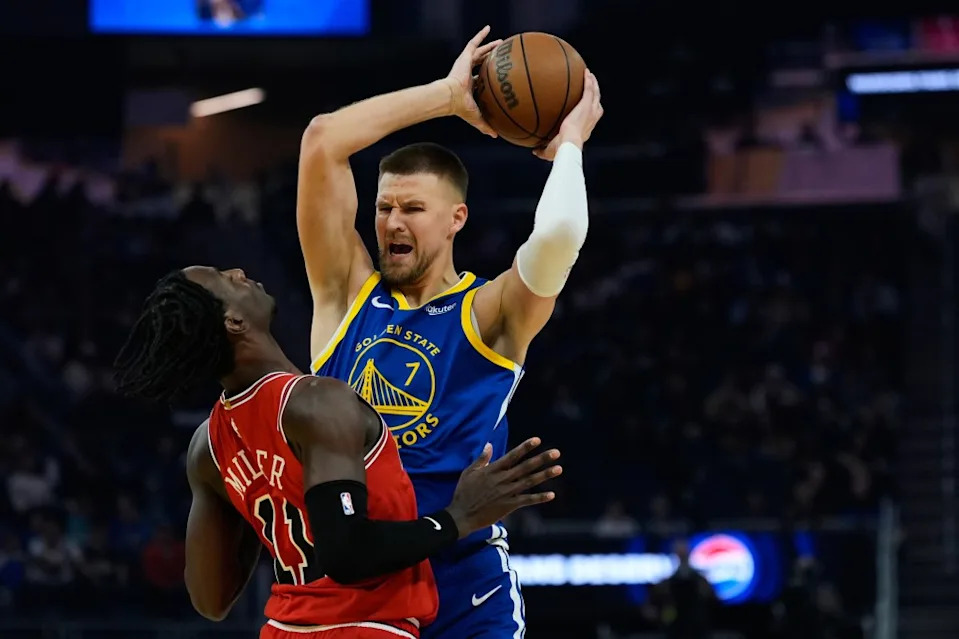 Warriors’ Kristaps Porziņģis is defended by Bulls forward Leonard Miller Tuesday, March 10 in San Francisco. AP