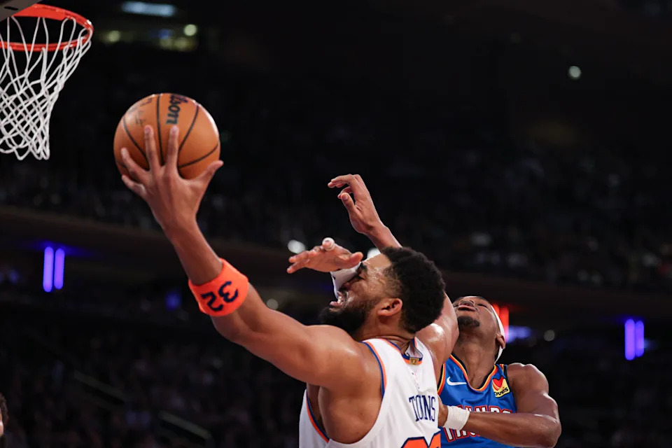 Mar 4, 2026; New York, New York, USA; New York Knicks center Karl-Anthony Towns (32) rebounds against Oklahoma City Thunder guard Shai Gilgeous-Alexander (2) during the second half at Madison Square Garden. Mandatory Credit: Vincent Carchietta-Imagn Images