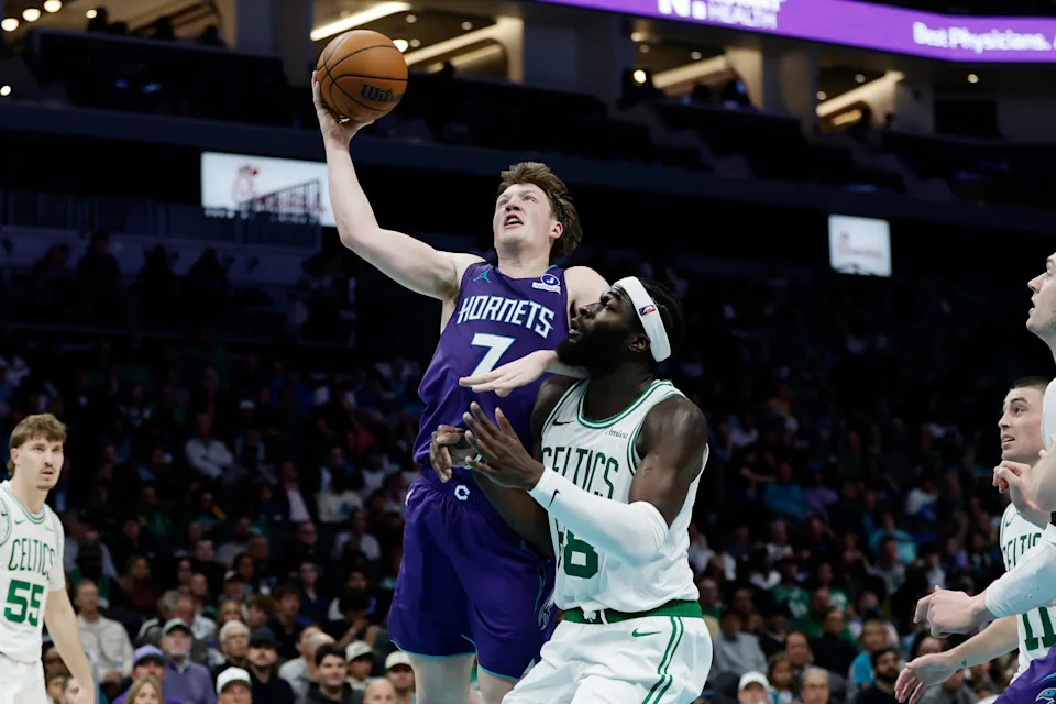 Mar 29, 2026; Charlotte, North Carolina, USA; Charlotte Hornets guard/forward Kon Knueppel (7) drives to the basket past Boston Celtics center Neemias Queta (88) during the second half at Spectrum Center. Mandatory Credit: Brian Westerholt-Imagn Images