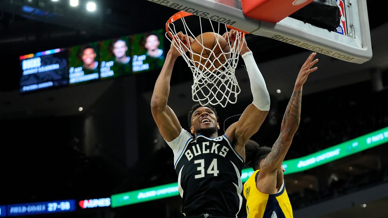 Milwaukee Bucks' Giannis Antetokounmpo (34) dunks past Indiana Pacers' Obi Toppin during the second half of an NBA basketball game, Sunday, March 15, 2026, in Milwaukee.