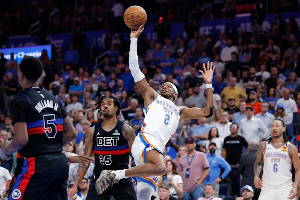 Mar 30, 2026; Oklahoma City, Oklahoma, USA; Oklahoma City Thunder guard Shai Gilgeous-Alexander (2) shoots as he fall back beside Detroit Pistons forward Tolu Smith (35) during the second half at Paycom Center. Mandatory Credit: Alonzo Adams-Imagn Images