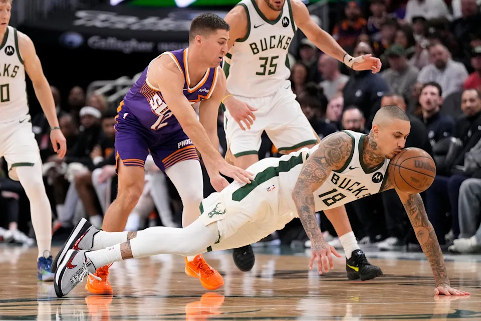 Mar 10, 2026; Milwaukee, Wisconsin, USA; Milwaukee Bucks forward Kyle Kuzma (18) chases the loose ball in front of Phoenix Suns guard Collin Gillespie (12) during the fourth quarter at Fiserv Forum. Mandatory Credit: Jeff Hanisch-Imagn Images