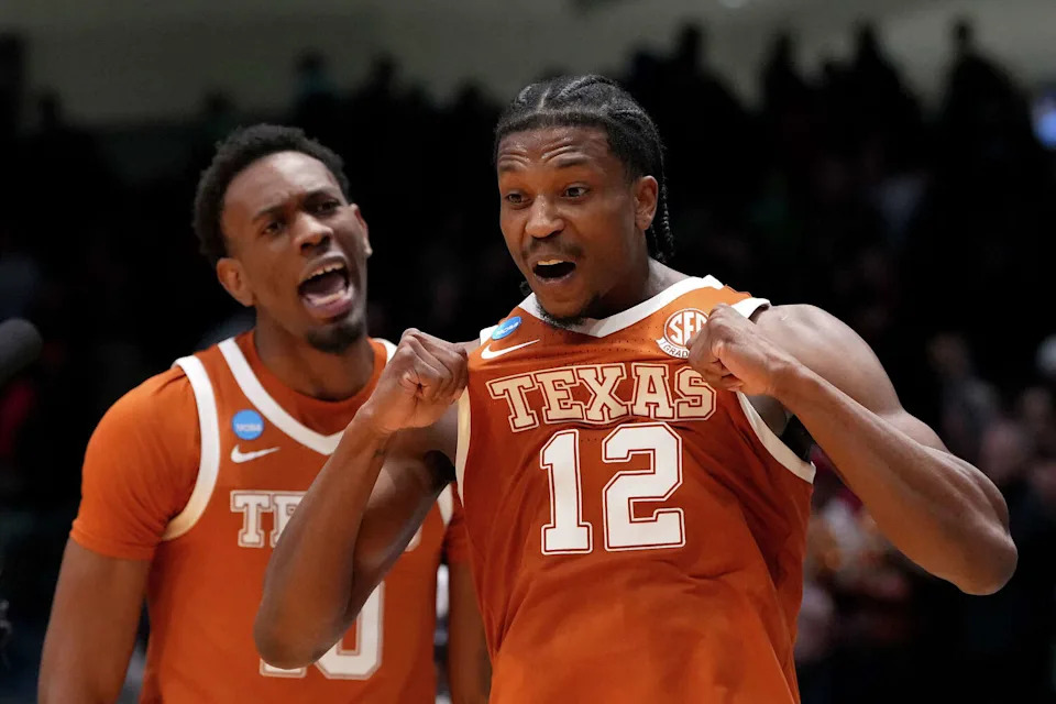 Texas guard Tramon Mark (12) celebrates with teammate Nic Codie after making the game winning shot against NC State Wolfpack during the second half of a First Four game in the 2026 NCAA men's basketball tournament March 17, 2026 at UD Arena in Dayton, Ohio. (Dylan Buell/Getty Images)