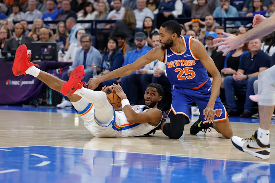 Mar 29, 2026; Oklahoma City, Oklahoma, USA; Oklahoma City Thunder guard Isaiah Joe (11) and New York Knicks guard Mikal Bridges (25) fight for control of a loose ball during the first half at Paycom Center. Mandatory Credit: Alonzo Adams-Imagn Images