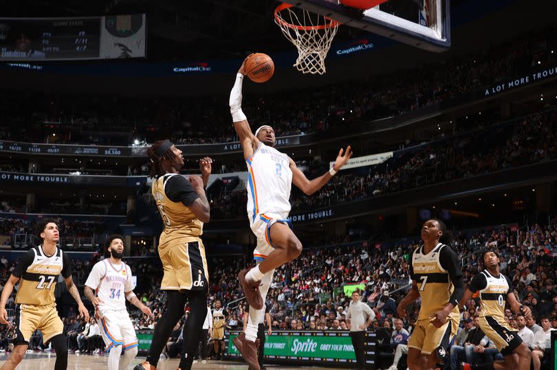 Shai Gilgeous-Alexander drives to the basket against the Washington Wizards