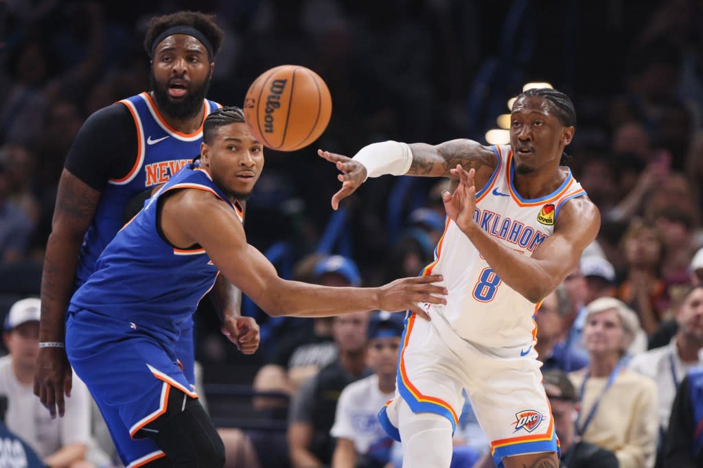 Oklahoma City Thunder guard Jalen Williams (8) passes the ball away from New York Knicks guard Miles McBride, front left, and center Mitchell Robinson, back left, during the first half. AP