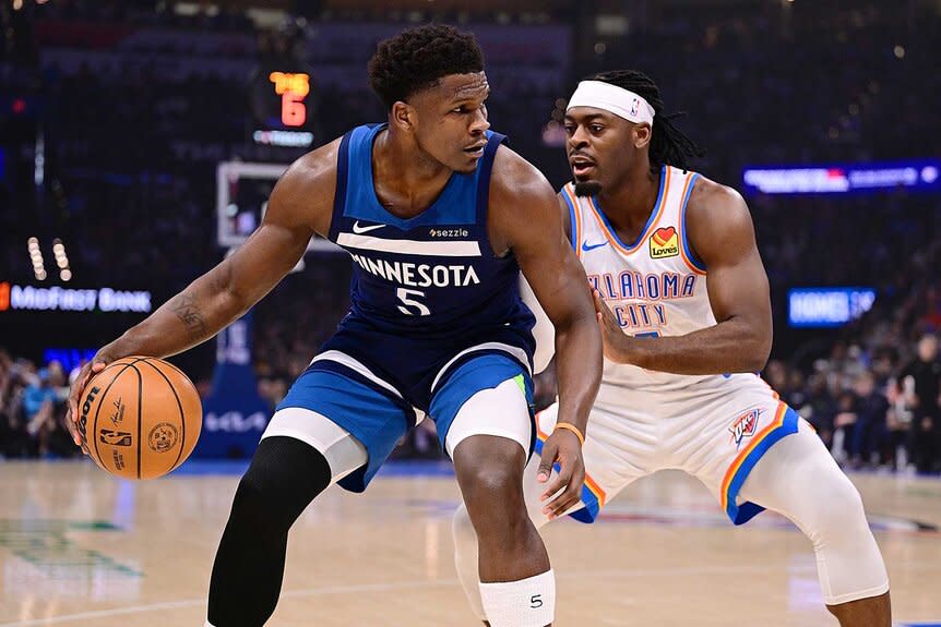 Anthony Edwards of the Minnesota Timberwolves handles the ball while being defended by Luguentz Dort of the Oklahoma City Thunder.