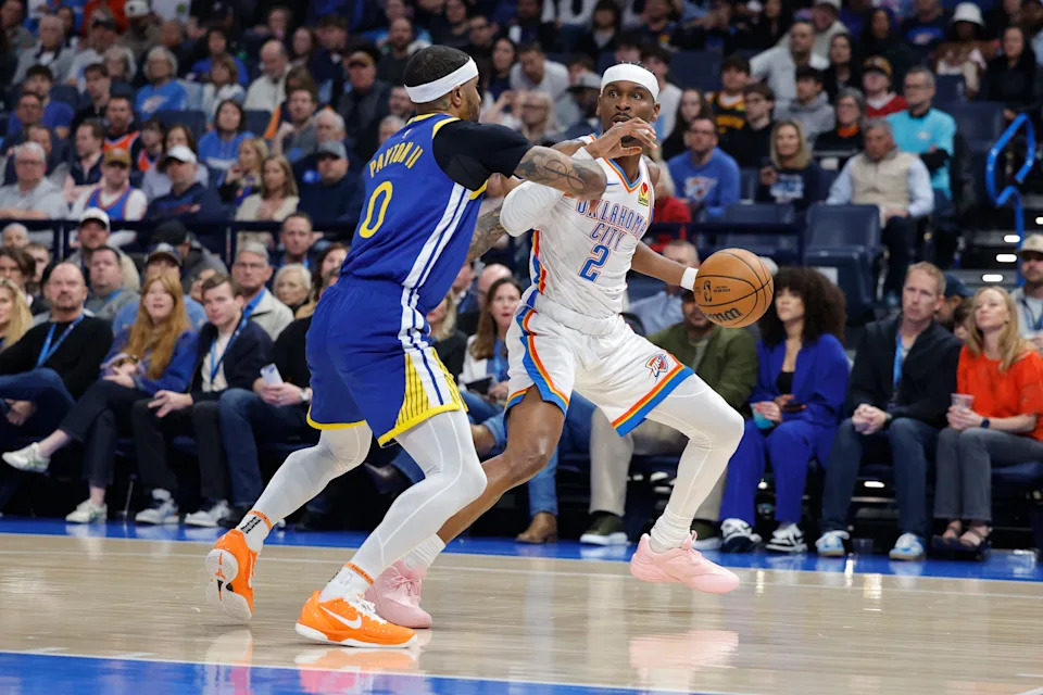 Mar 7, 2026; Oklahoma City, Oklahoma, USA; Oklahoma City Thunder guard Shai Gilgeous-Alexander (2) moves the ball as Golden State Warriors guard Gary Payton II (0) defends during the first half at Paycom Center. Mandatory Credit: Alonzo Adams-Imagn Images