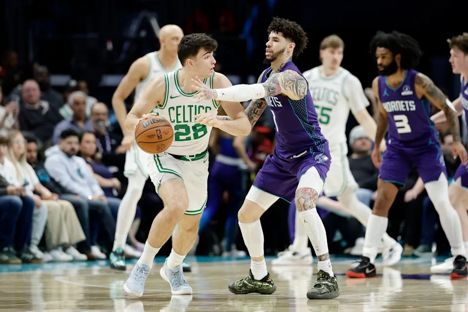Mar 29, 2026; Charlotte, North Carolina, USA; Boston Celtics guard Hugo González (28) keeps the ball away from Charlotte Hornets guard LaMelo Ball (1) during the second half at Spectrum Center. Mandatory Credit: Brian Westerholt-Imagn Images