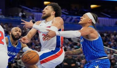Detroit Pistons guard Cade Cunningham, center, loses control of the ball as he tries to go between Orlando Magic guard Jevon Carter, left, and forward Paolo Banchero during the first half of an NBA basketball game, Sunday, March 1, 2026, in Orlando, Fla. (AP Photo/John Raoux)