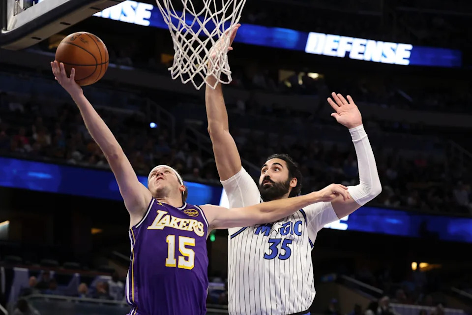Los Angeles Lakers guard Austin Reaves (15) shoots the ball past Orlando Magic center Goga Bitadze (35) in the second quarter at Kia Center. Nathan Ray Seebeck-Imagn Images