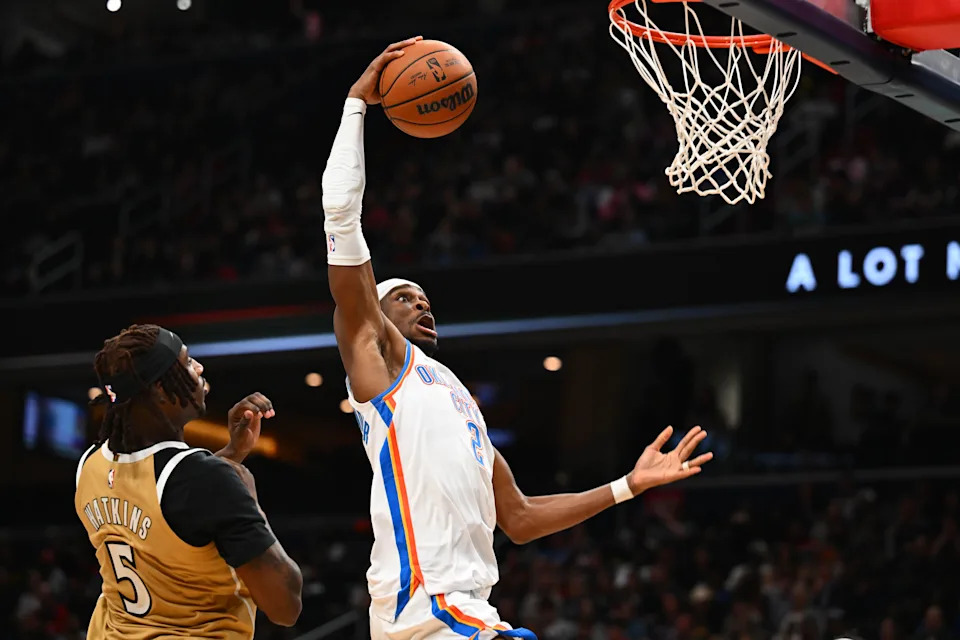 Mar 21, 2026; Washington, District of Columbia, USA; Oklahoma City Thunder guard Shai Gilgeous-Alexander (2) dunks as Washington Wizards forward Jamir Watkins (5) looks on during the second half at Capital One Arena. Mandatory Credit: Brad Mills-Imagn Images