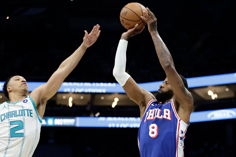 Mar 28, 2026; Charlotte, North Carolina, USA; Philadelphia 76ers forward Paul George (8) shoots over Charlotte Hornets forward Grant Williams (2) during the first quarter at Spectrum Center. Mandatory Credit: Brian Westerholt-Imagn Images