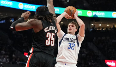 Cooper Flagg of the Dallas Mavericks shoots over Robert Williams III of the Portland Trail Blazers during the first half at Moda Center on March 27, 2026.