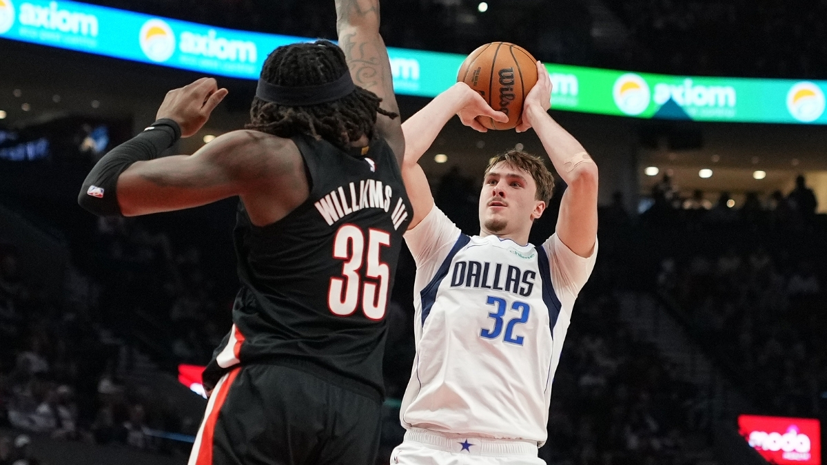 Cooper Flagg of the Dallas Mavericks shoots over Robert Williams III of the Portland Trail Blazers during the first half at Moda Center on March 27, 2026.