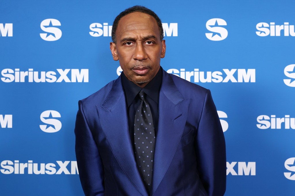 Stephen A. Smith stands in front of a blue background with the SiriusXM logo.