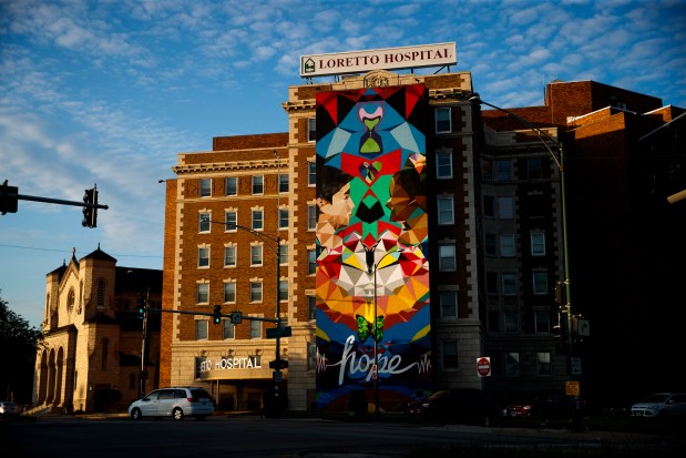 The sun sets over Loretto Hospital on June 2, 2021. (Armando L. Sanchez/Chicago Tribune)
