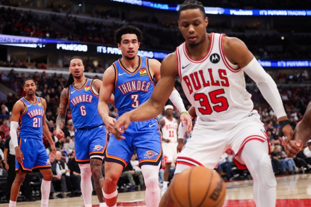 Oklahoma City Thunder guard Jared McCain (3) and Chicago Bulls forward Isaac Okoro (35) chase the ball as it goes out of bounds during the first quarter at the United Center March 3, 2026 in Chicago. (Armando L. Sanchez/Chicago Tribune)