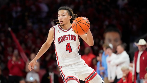 Houston guard Kingston Flemings controls the ball during the second half of a game against Baylor, Wednesday March 4, 2026, in Houston. (AP Photo/Karen Warren)