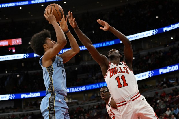 Memphis Grizzlies' Jaylen Wells, left, goes up to shoot against Chicago Bulls' Leonard Miller during the first half of a game in Chicago, Monday, March 16, 2026. (AP Photo/Paul Beaty)