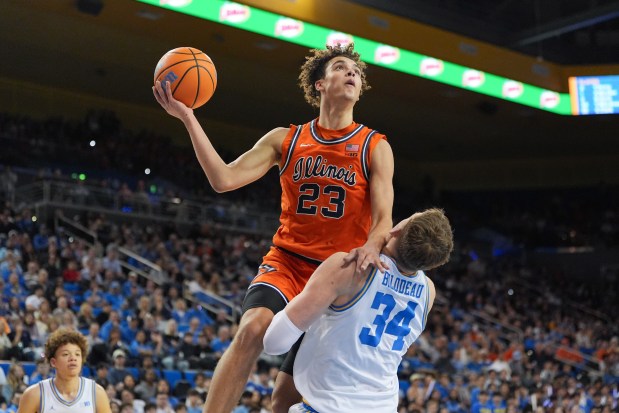 Illinois guard Keaton Wagler goes up for a basket over UCLA forward Tyler Bilodeau during the first half of a game in Los Angeles, Saturday, Feb. 21, 2026. (AP Photo/Jae C. Hong)