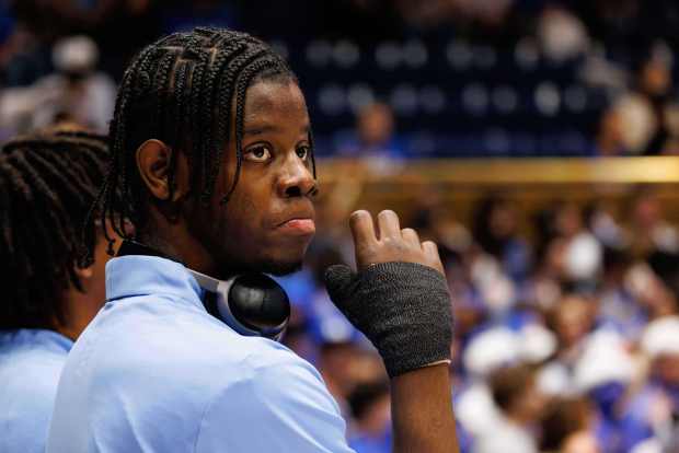 North Carolina's Caleb Wilson watches warmups with an injured hand before a game against Duke in Durham, N.C., Saturday, March 7, 2026. (AP Photo/Ben McKeown)