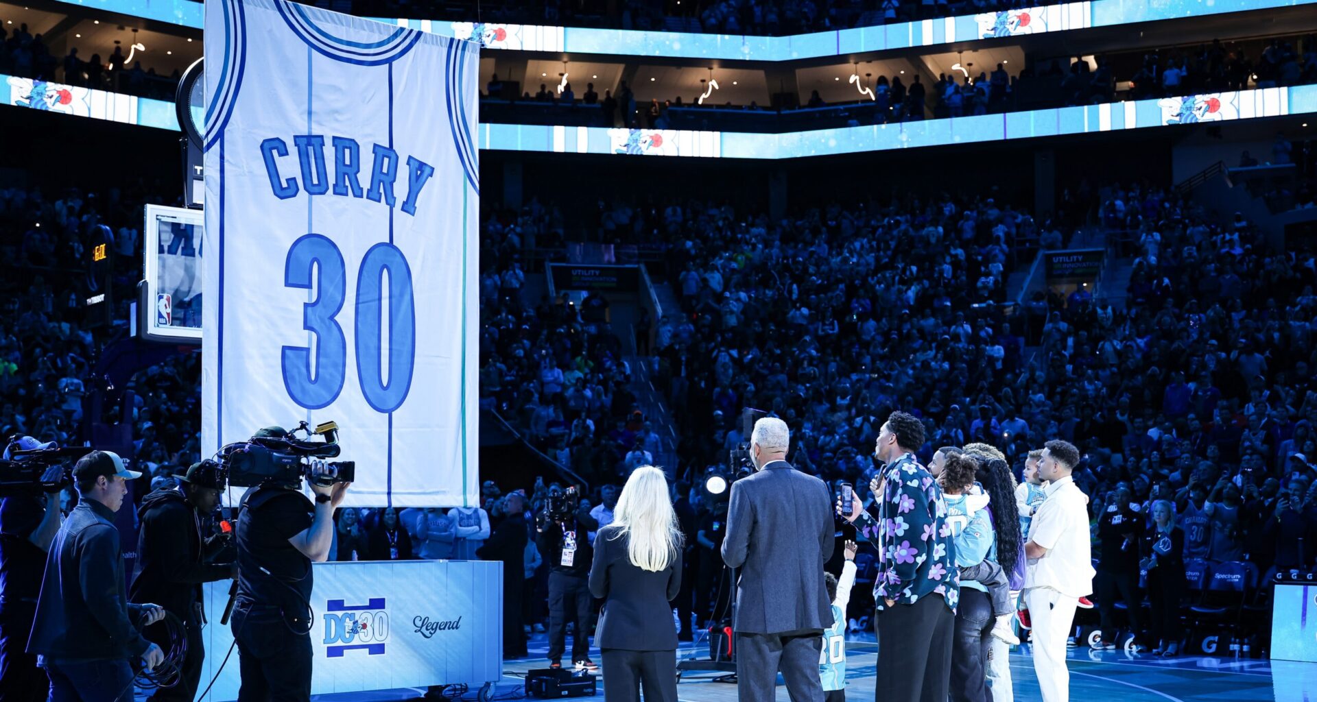 Dell Curry reflects as his No. 30 jersey is sent to the rafters by Hornets