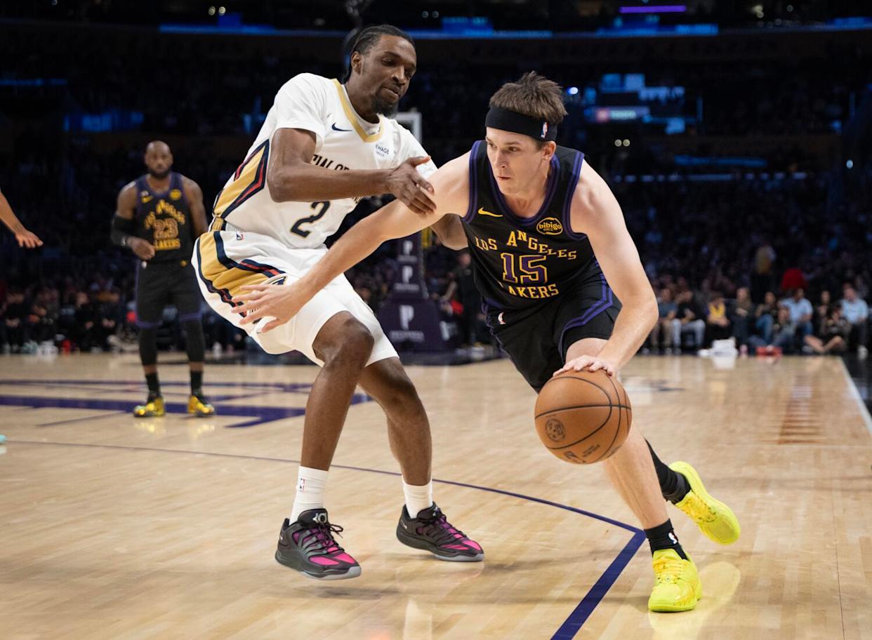 Lakers guard Austin Reaves dribbles around Pelicans forward Herbert Jones on Tuesday at Crypto.com Arena.