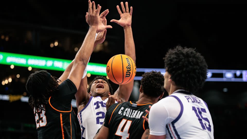 TCU Horned Frogs forward Xavier Edmonds (24) loses the ball after colliding with Oklahoma State Cowboys center Benjamin Ahmed (23) during the first half at T-Mobile Center, in Kansas City, Missouri on March 11. - William Purnell/Imagn Images/Reuters Connect