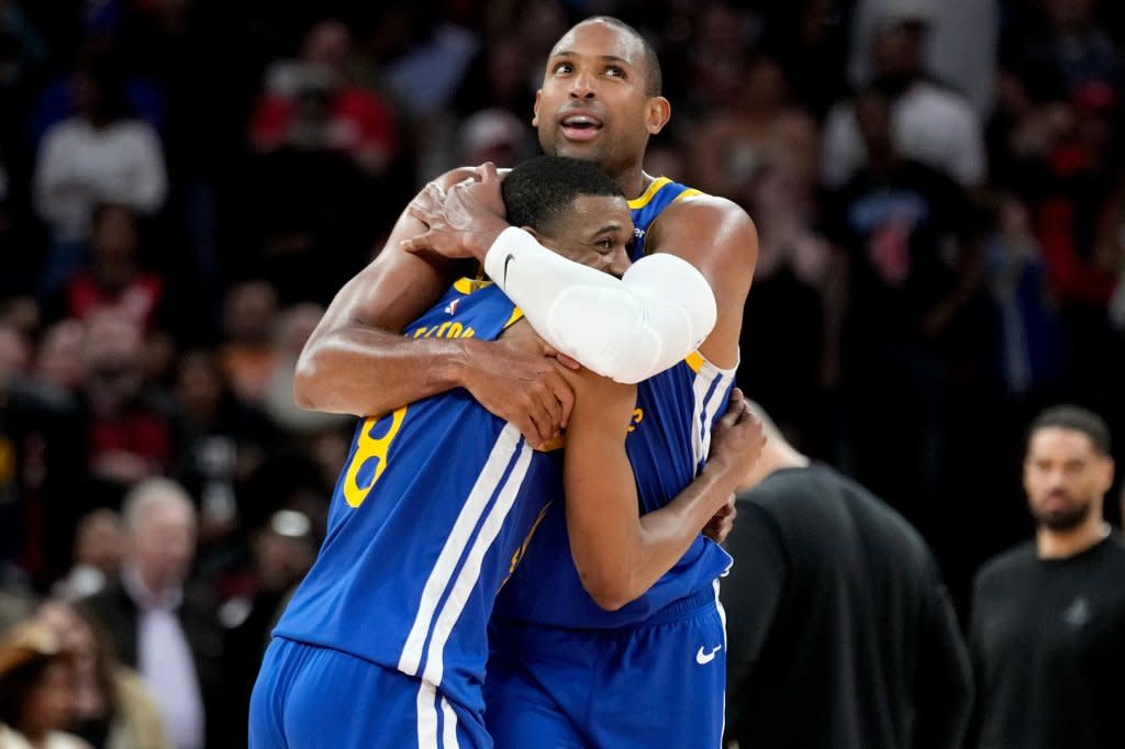 Warriors guard De’Anthony Melton (left) hugs Al Horford after making a basket against the Rockets during overtime Thursday in Houston. (AP Photo/Eric Christian Smith) AP