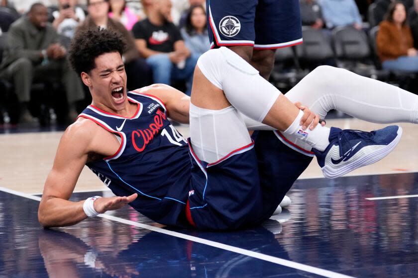 Los Angeles Clippers center Yanic Konan Niederhauser writhes on the floor after he was injured during the first half of an NBA basketball game against the Indiana Pacers, Wednesday, March 4, 2026, in Inglewood, Calif. (AP Photo/Mark J. Terrill)