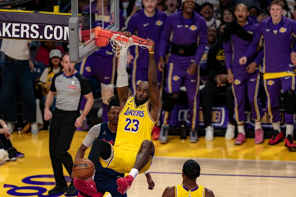 Los Angeles Lakers forward LeBron James (23) dunking and hanging from the rim during an NBA basketball game against the Washington Wizards on March 30th, 2026 in Los Angeles, CA.
