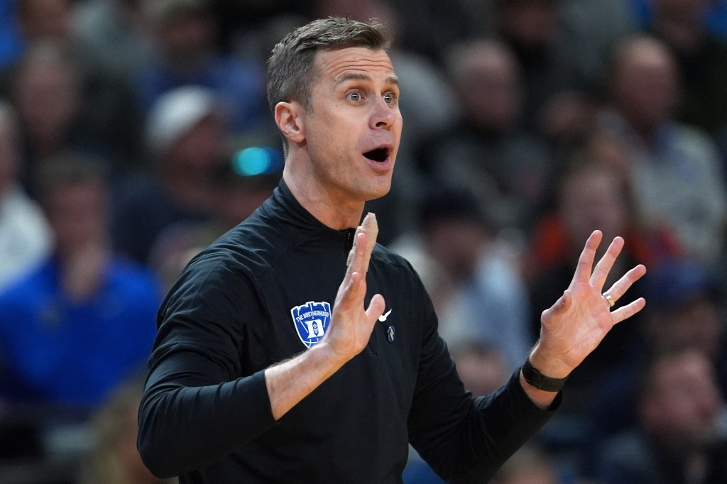 Duke Blue Devils head coach Jon Scheyer reacting in the first half of a game.