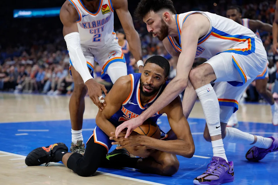 Mar 29, 2026; Oklahoma City, Oklahoma, USA; New York Knicks guard Mikal Bridges (25) and Oklahoma City Thunder center Chet Holmgren (7) fight for a loose ball during the first half at Paycom Center. Mandatory Credit: Alonzo Adams-Imagn Images