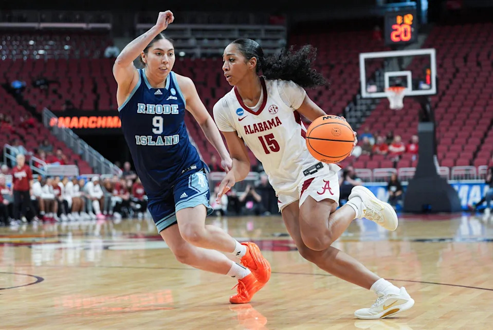 Alabama Crimson Tide guard Ta'mia Scott (15) drives past Rhode Island Rams forward Valentina Ojeda (9) at the 2026 NCAA Women's March Madness basketball tournament at the KFC Yum Center In Louisville, Kentucky. March 21, 2026.