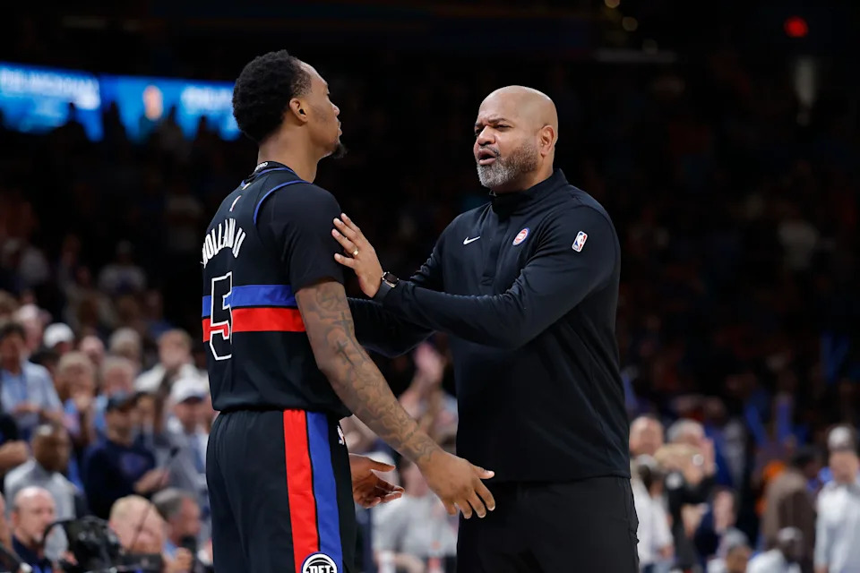Mar 30, 2026; Oklahoma City, Oklahoma, USA; Detroit Pistons head coach J.B. Bickerstaff holds back forward Ronald Holland II (5) after he received a foul call from an official during the second half at Paycom Center. Mandatory Credit: Alonzo Adams-Imagn Images