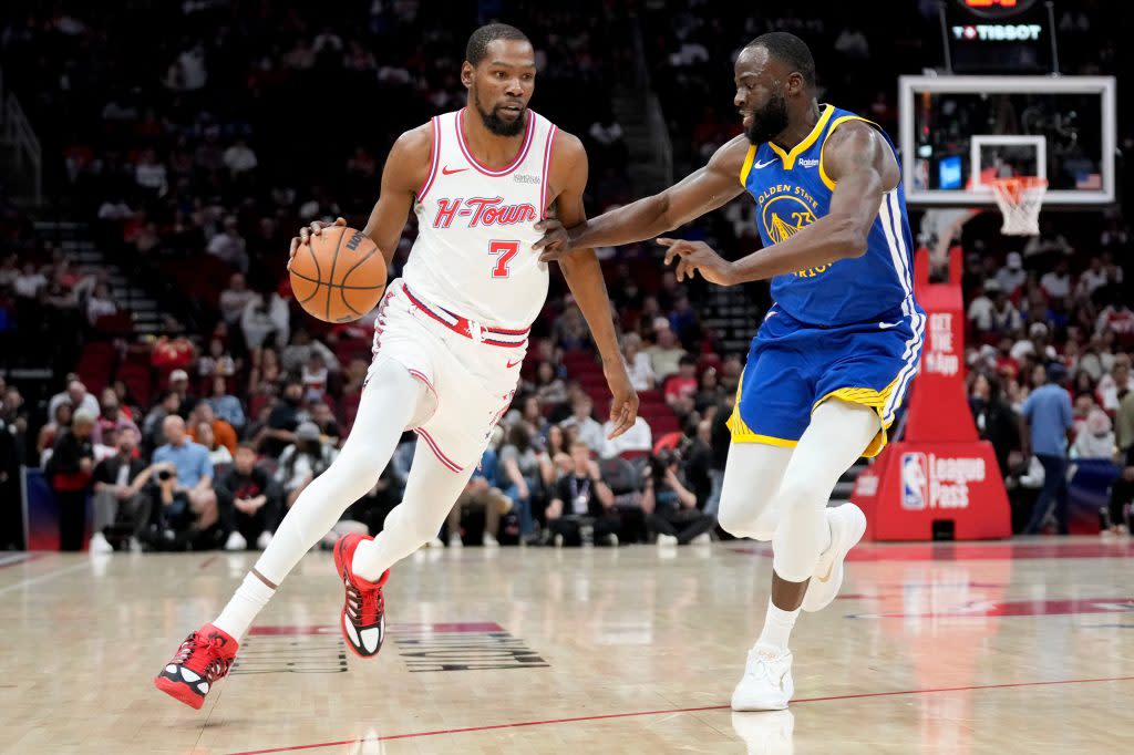 Rockets forward Kevin Durant dribbles as Warriors forward Draymond Green defends Thursday in Houston. (AP Photo/Eric Christian Smith) AP
