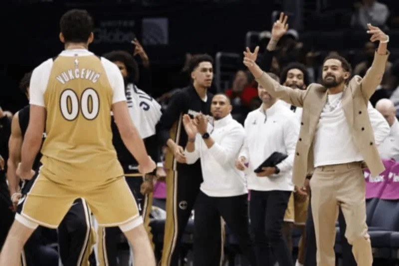 Jan 9, 2026; Washington, District of Columbia, USA; Newly acquired Washington Wizards guard Trae Young (R) celebrates from the bench with Washington Wizards forward Tristan Vukcevic (00) against the New Orleans Pelicans in the second half at Capital One Arena. Mandatory Credit: Geoff Burke-Imagn Images