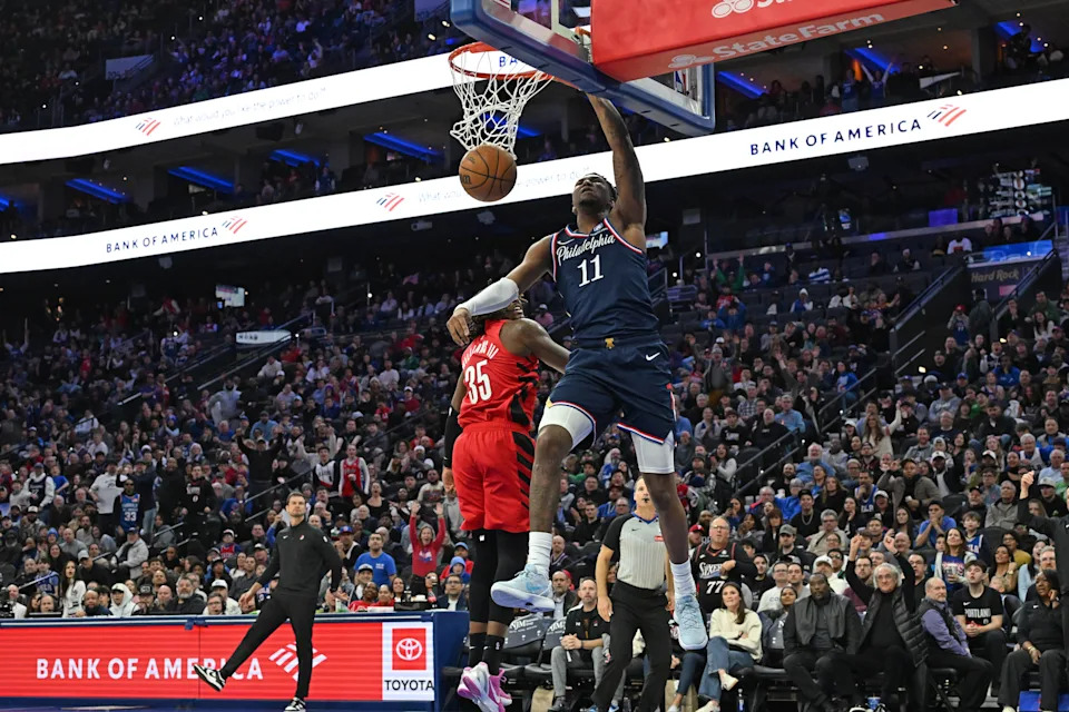 Mar 15, 2026; Philadelphia, Pennsylvania, USA; Philadelphia 76ers forward Justin Edwards (11) dunks past Portland Trail Blazers center Robert Williams III (35) during the second half at Xfinity Mobile Arena. Mandatory Credit: Eric Hartline-Imagn Images