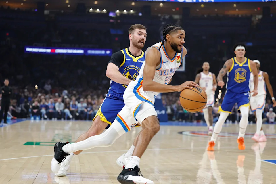 Mar 7, 2026; Oklahoma City, Oklahoma, USA; Oklahoma City Thunder guard Isaiah Joe (11) moves the ball past Golden State Warriors guard Pat Spencer (61) during the first half at Paycom Center. Mandatory Credit: Alonzo Adams-Imagn Images