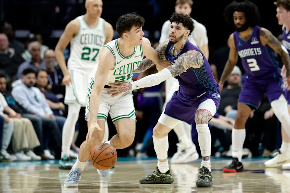 Mar 29, 2026; Charlotte, North Carolina, USA; Boston Celtics guard Hugo González (28) keeps the ball away from Charlotte Hornets guard LaMelo Ball (1) during the second half at Spectrum Center. Mandatory Credit: Brian Westerholt-Imagn Images