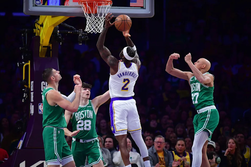 Feb 22, 2026; Los Angeles, California, USA; Los Angeles Lakers forward Jarred Vanderbilt (2) moves to the basket against Boston Celtics center Nikola Vucevic (4) guard Hugo Gonzalez (28) and guard Jordan Walsh (27) during the first half at Crypto.com Arena. Mandatory Credit: Gary A. Vasquez-Imagn Images