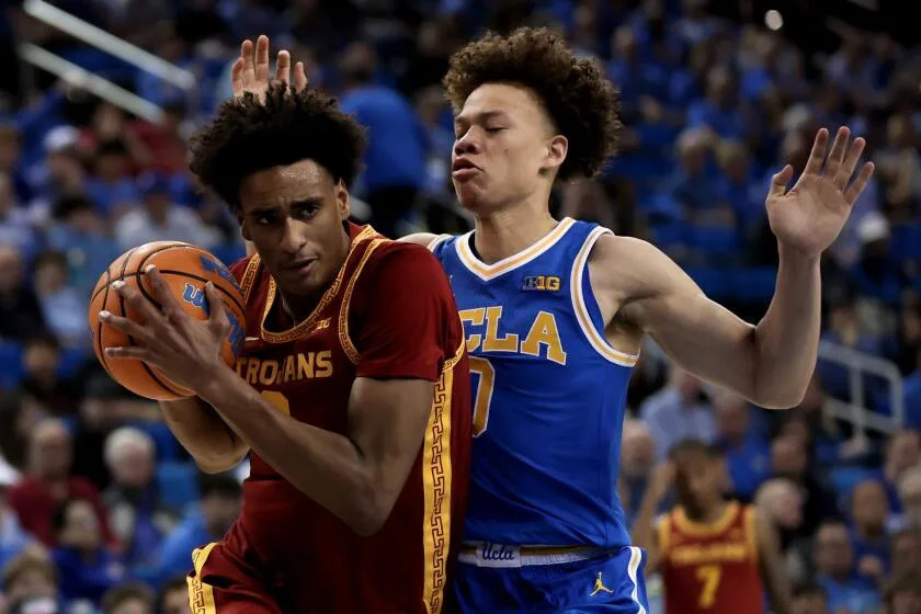 USC guard Alijah Arenas drives around UCLA guard Trent Perry at Pauley Pavilion on Tuesday.